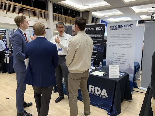 Jon Dionne talks to students at a STEM career fair