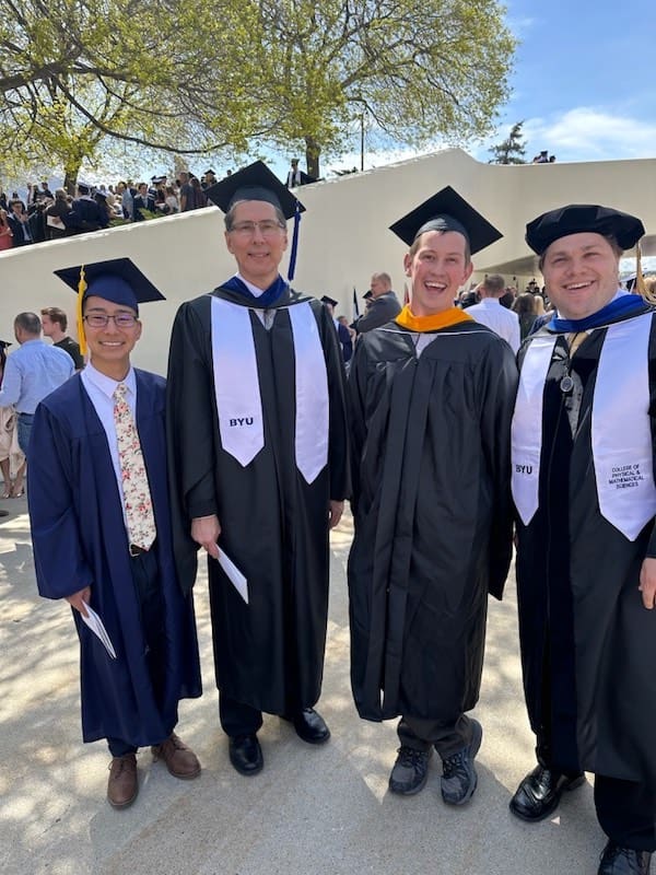 Jon Dionne and 3 other SDi employees in graduation regalia